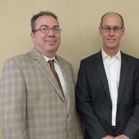 <p>Former Board President David W​a​rshaw handing over the gavel to new Board President Mike Stern.</p>