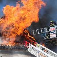 <p>Firefighters heavily doused the flames with ladder trucks in the front and back of the Wyckoff Avenue home in Mahwah.</p>