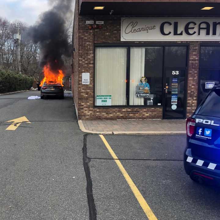 A car fire at a Rockland shopping center destroyed the vehicle and damaged one business.