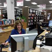 <p>Judy Silver on the reference desk at Paramus Public Library. Life goes on at the library until bids are reviewed prior to major renovation work.</p>