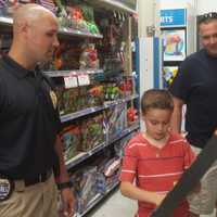 <p>Det. Ryan Sokerka with Nick Milo, 8, and his dad, Todd Milo, also on the force.</p>