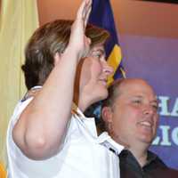 <p>Ridgewood Police Chief Jacqueline Luthcke takes her oath while standing next to her husband, Wayne</p>