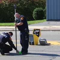 <p>Suffolk County Police investigators surveying the evidence after a 7-Eleven store clerk killed a would-be shoplifter in Melville.</p>