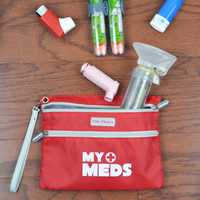 <p>AllerMates medical bag with items.</p>