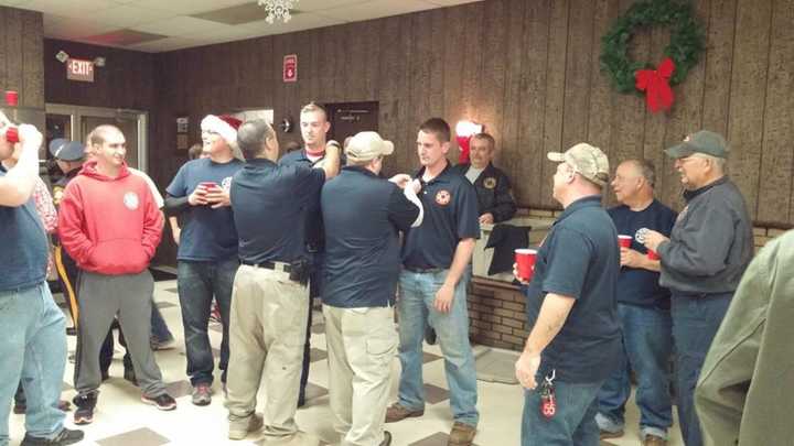 Left, Pompton Lakes Capt. James Titus Jr. pins incoming Capt. Derrek Mangin, who will be captain of Ladder Co. 52. Right, Capt. Tim Scott Jr. pins incoming Capt. Bill Breur Jr. of Engine Co. 51.