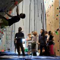 <p>Climbers encourage others to reach new heights.</p>