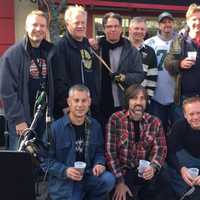 <p>Joe Oriente, bottom left, Rich Leonarz, far right in the back row, and the musicians in Dads Night Band takes a break from making music at the 10th Annual Motorcycle Classic to throw back some brews.</p>