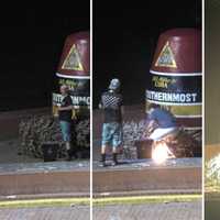 <p>A webcam at Key West&#x27;s southernmost point shows the pair sitting next to the buoy, taking cellphone photos and then setting fire to a Christmas tree in front of the landmark.</p>