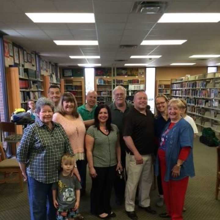 Elected officials library trustees (and their grandchildren!) cheer the 75th anniversary.