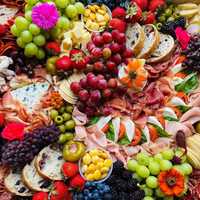 <p>PlatedByD&#x27;s charcuterie boards feature all types of artisan meats, cheese, fruits, veggies, snacks, desserts and more.</p>