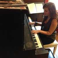 <p>Christina &quot;Alexa&quot; Houlis practices the piano at Cool Beans in Oradell.</p>