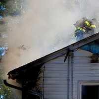 <p>Firefighters battle blaze on Plympton Street in New Milford.</p>