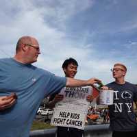 <p>A Damarest Farm visitor donates to THON before apple picking on Saturday in Hillsdale.</p>