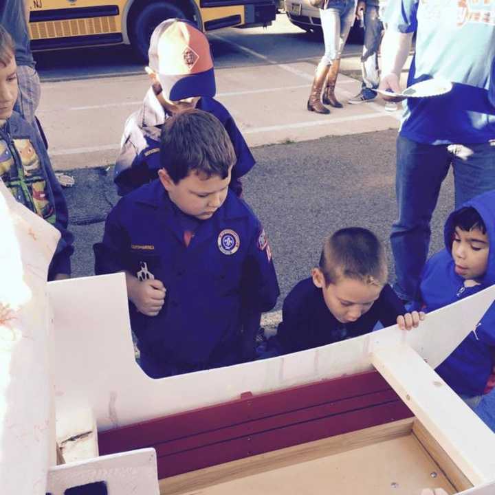 Saddle Brook Cub Scouts work on pinewood derby vehicles.