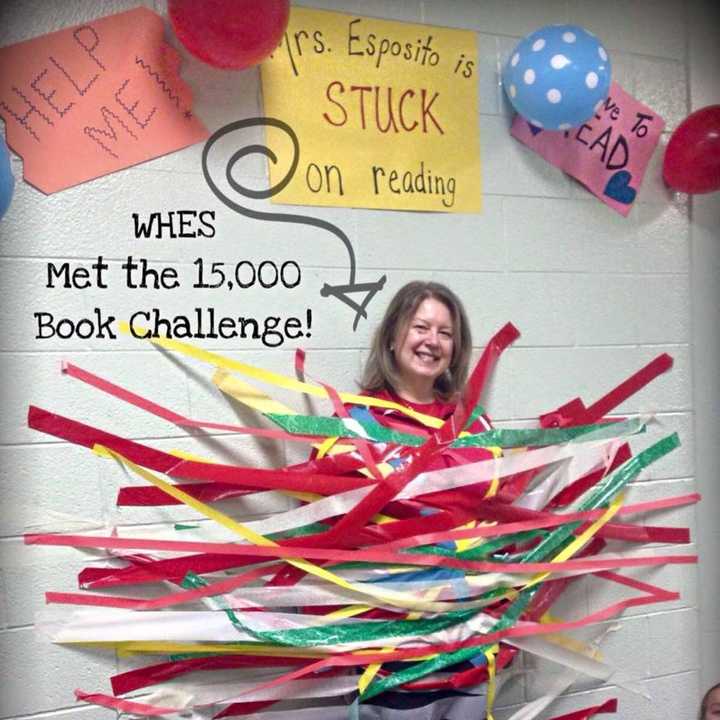 Students at West Haverstraw Elementary School met Mary Esposito&#x27;s reading challenge. As a reward for their hard work, the children got to tape Esposito to the wall because she was &quot;stuck&quot; on reading.