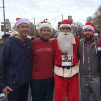 <p>Former Dumont runner Brian Lang, center, runs for and breaks a world record for a charity. </p>