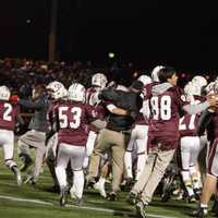 <p>Ridgewood High School students storm the field after the last down.</p>