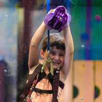 <p>A young climber scales the plexiglass wall at Northvale&#x27;s High Exposure, LLC.</p>