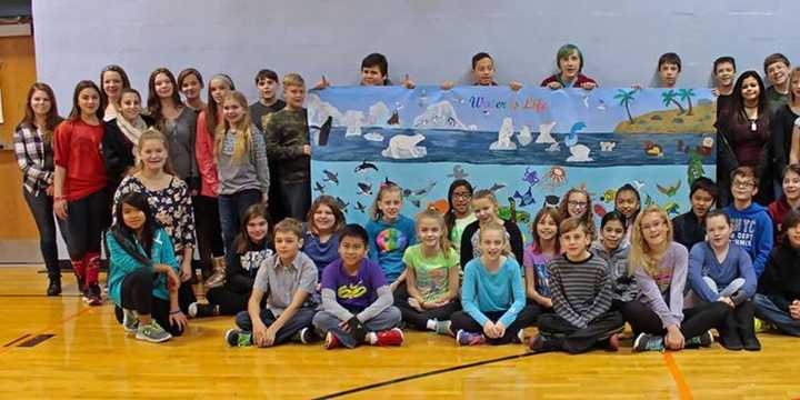 Haskell School students show off their art work. 