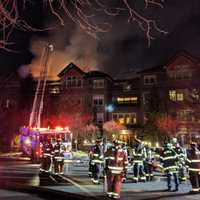 <p>Fire crews battle a raging blaze at a condo complex at 100 Richards Ave. in Norwalk early Monday evening.</p>