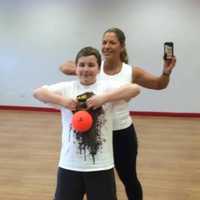 <p>Tricia Serow Bazzano of Ringwood helps her son exercise.</p>