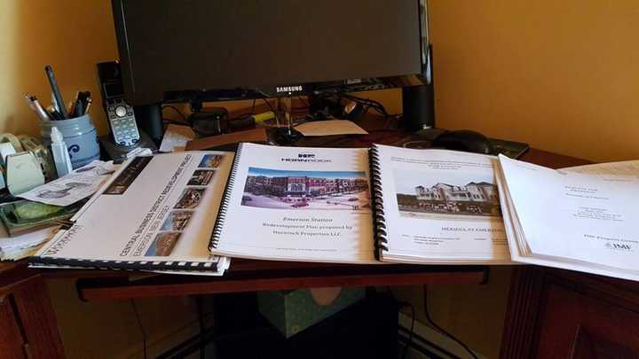 Emerson received four proposals – pictured here on Mayor Lou Lamatina&#x27;s desk – for its Central Business District.