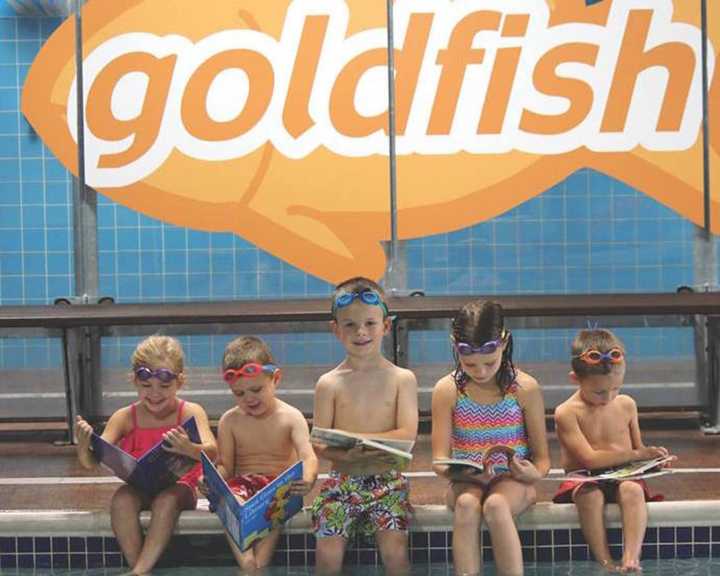 Kids read at Goldfish Swim School in Wyckoff.