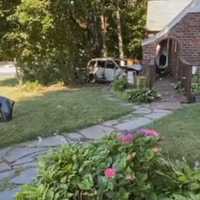 <p>The front bumper of the Accord lies on the North Wilson Avenue lawn near the van.</p>