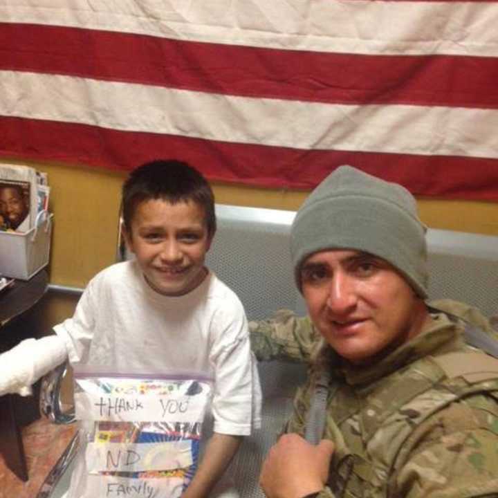 Fernando Moreno-Rivas, who was killed in a wrong-way crash on Route 8, presents gifts to an Afghanistan boy in 2012. Fernando Moreno-Rivas was an Army medic.