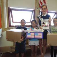 <p>Izabela Hasandjekic donates goodies to Cliffside Park School No. 3 for its next set of care packages for troops.</p>