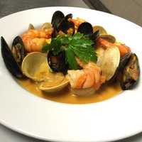 <p>Mariscada dish at Ibiza in Danbury (shrimp, sea scallops, mussels, little neck clams, coconut and saffron broth).</p>