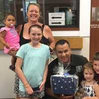 <p>Local Ramapo residents show their appreciation for a Ramapo police officer as part of the Blue Wave Shore to Shore Appreciation Week.</p>