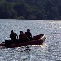 <p>Danbury firefighters set out on the zodiac rescue boat on West Lake Reservoir to rescue four swimmers from an island.</p>