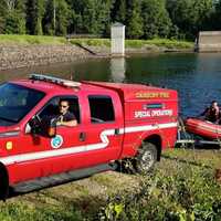 <p>The Danbury Fire Department prepares to launch the zodiac rescue boat into West Lake Reservoir near the pump station off Middle River Road.</p>