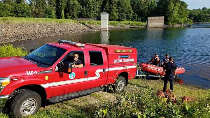 The Danbury Fire Department prepares to launch the zodiac rescue boat into West Lake Reservoir near the pump station off Middle River Road.