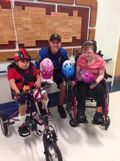 Bicycle Police Officer Delivers Donated Helmets To Special Needs Hospital