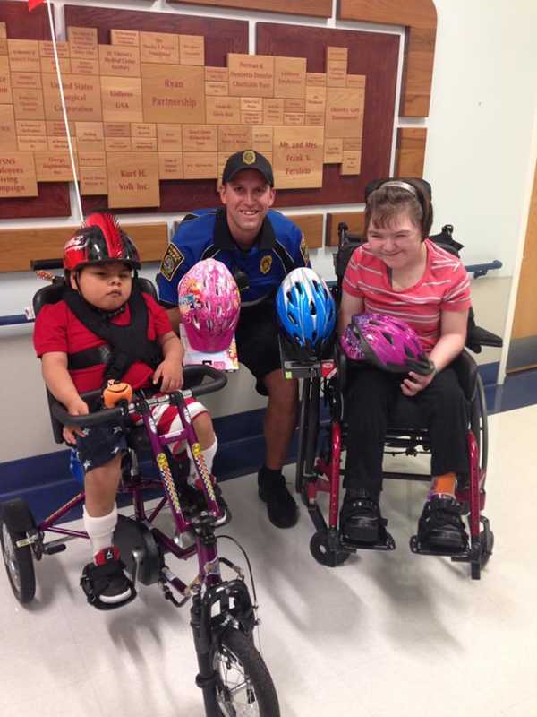 Bicycle Police Officer Delivers Donated Helmets To Special Needs Hospital