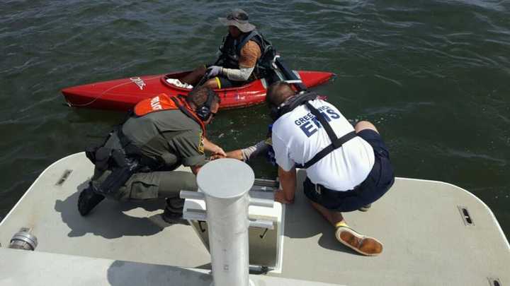 Officers and a medic rescued a boater whose kayak had sunk off the coast of Greenwich this weekend.