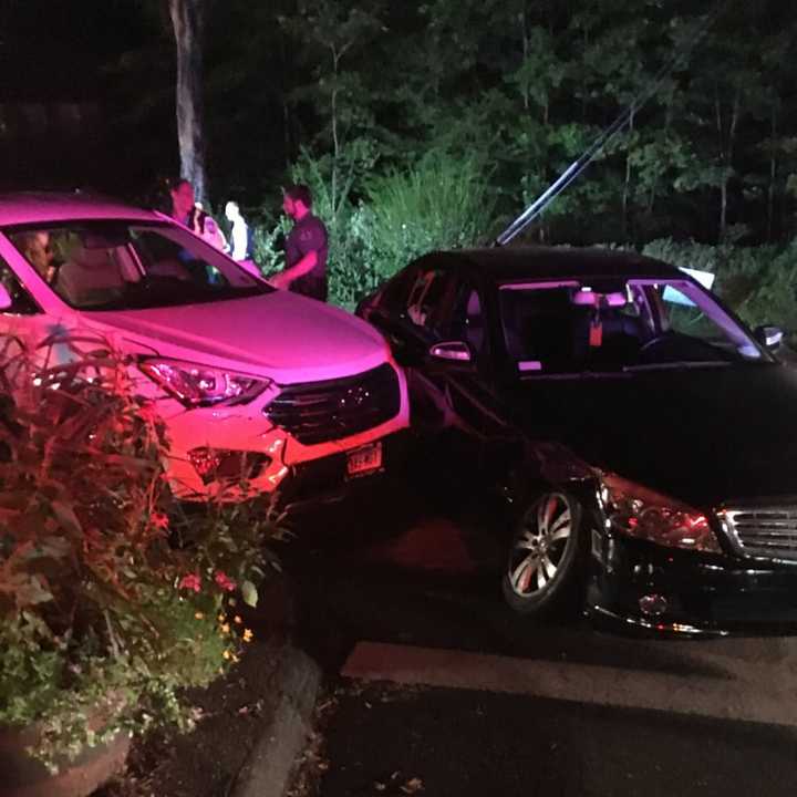 Weston Volunteer Fire Department works at the scene of a two-car crash on Old Hyde Road late Friday.