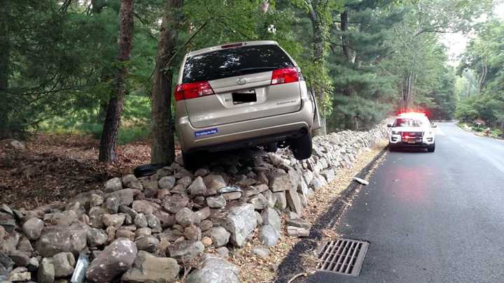 The vehicle came to rest on a rock wall.