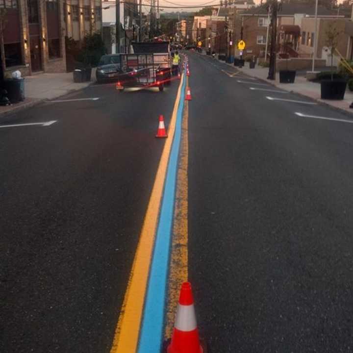 Carlstadt DPW workers painting the thin blue line on Hackensack Avenue.