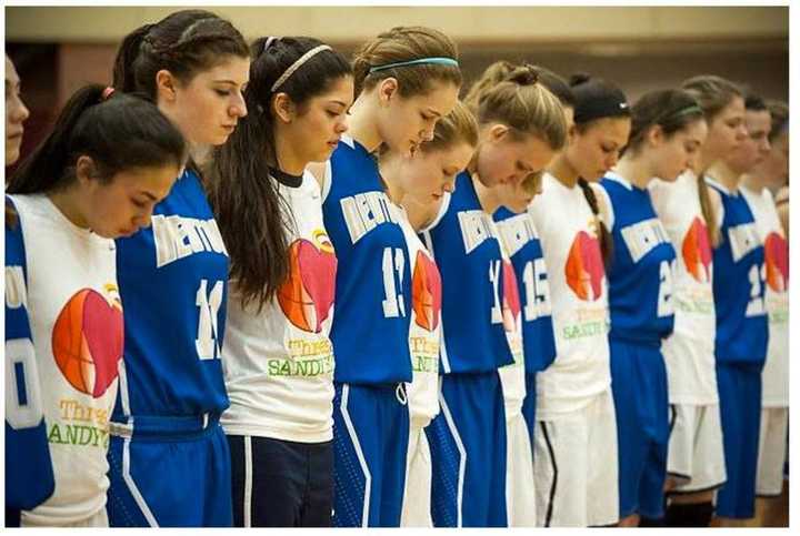 Saddle River Day School and Newtown High School athletes share a moment of silence to remember the 26 victims killed in the Sandy Hook Shooting.