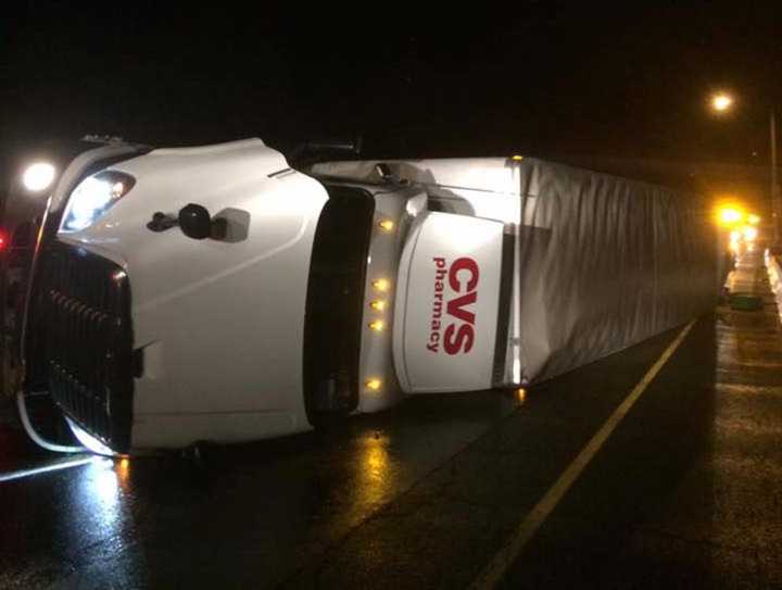 A CVS truck lies on its side on the shoulder of I-84 in Danbury after an early morning crash Wednesday.