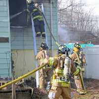 <p>Central Nyack firefighters work to extinguish a fire a garbage-filled home on Waldron Avenue.</p>