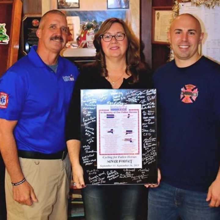 Patty Barnas and her son, Kevin, accept plaque.