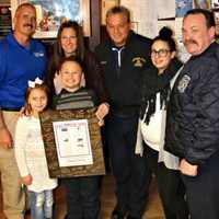 <p>Jeff Morse, founder/president of the Brotherhood Ride, with the Woods family in Wallingon.</p>