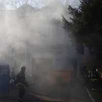 <p>A burning dumpster produces a lot of smoke Wednesday on Westfair Drive in Westport.</p>