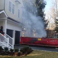 <p>A burning dumpster is very close to a  residence on Westfair Drive in Westport on Wednesday afternoon.</p>