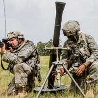 <p>Spc. Hakeem English, a soldier assigned to Headquarters Co., 2nd Battalion, 108th Infantry, sets up a 60mm mortar while Spc. Elliot Beaumont provides security at Fort Polk, La.,</p>