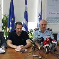 <p>Crete police officials discuss the case.</p>